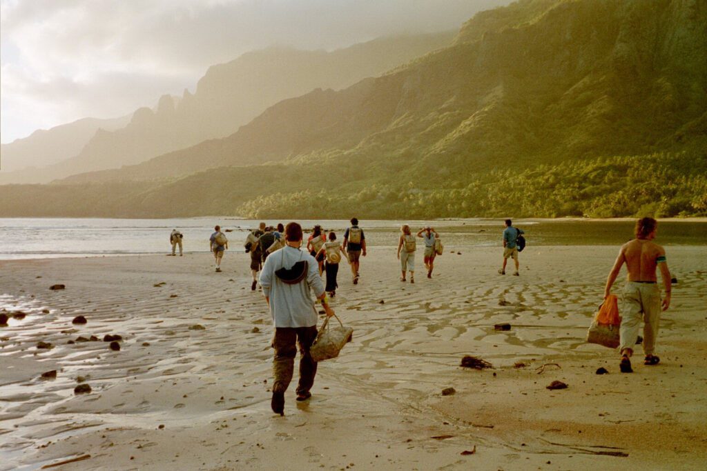 A group of people walking on the beach