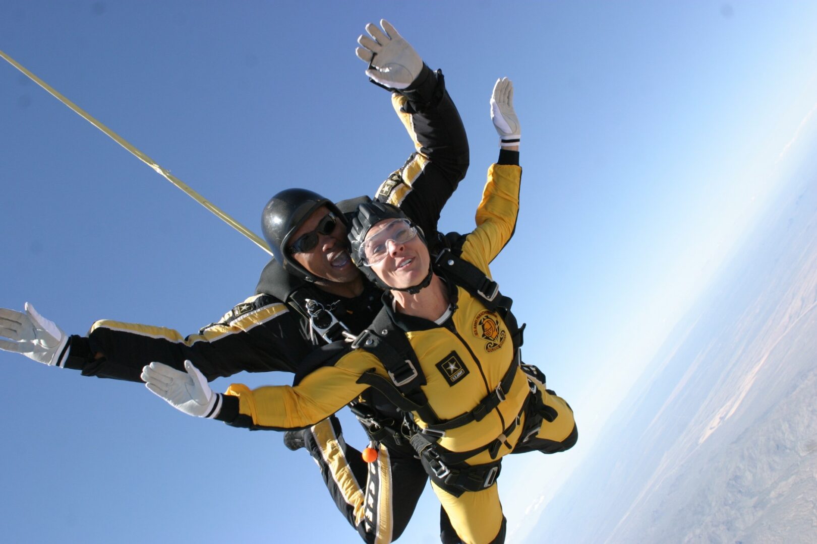 Two people are skydiving in the air.