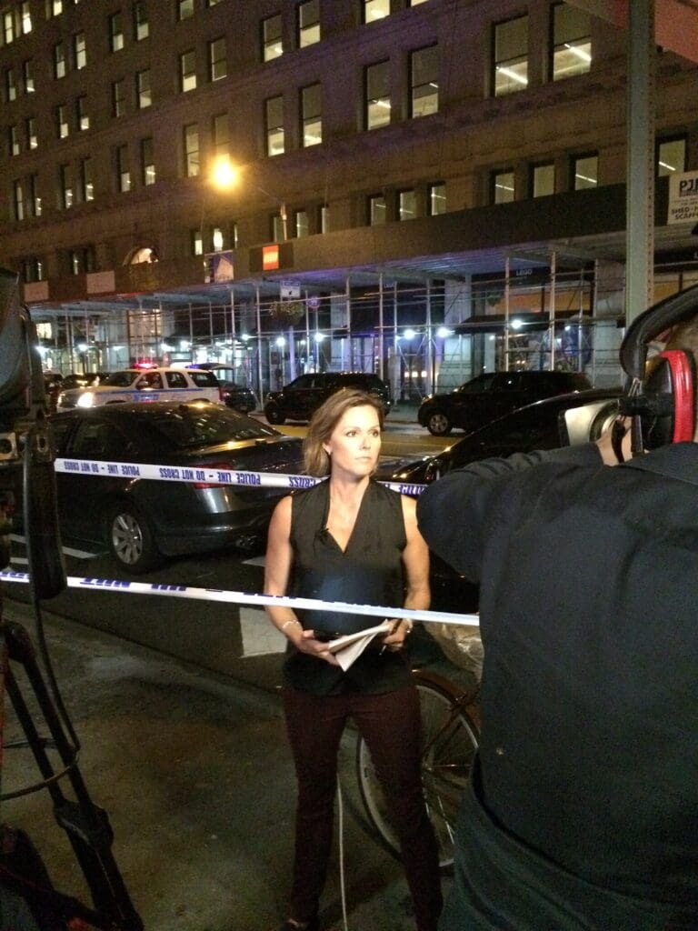 A woman standing in front of a camera.