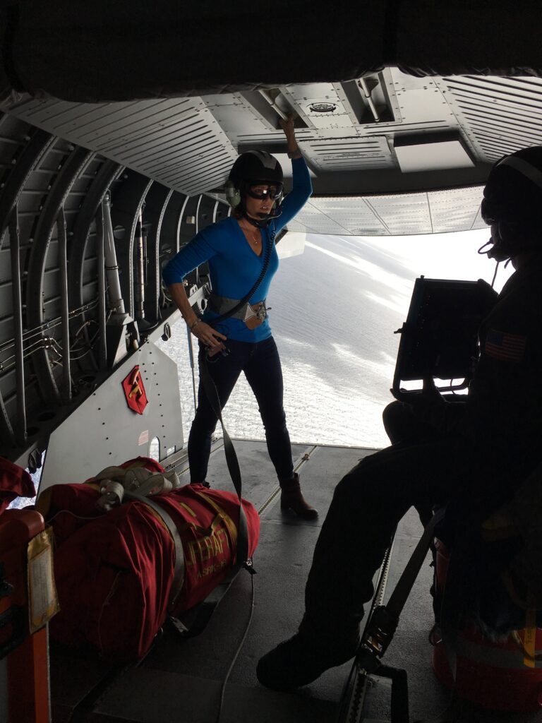 A woman standing in the middle of an airplane.