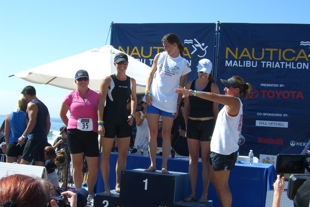 A group of women standing on top of a podium.
